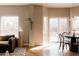 Cozy living room with wood floors, natural light, a couch, and a dining area at 2741 Sunset Way, Erie, CO 80516