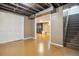 Spacious basement with finished flooring, exposed ceiling, and stairs to the upper level at 2060 S Lowell Blvd, Denver, CO 80219