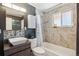 Modern bathroom features sleek tile surround, decorative mosaic tile, and dark gray accent walls at 2060 S Lowell Blvd, Denver, CO 80219