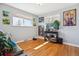 Cozy bedroom features warm hardwood floors, light gray walls, and a sunlit window view at 2060 S Lowell Blvd, Denver, CO 80219