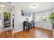 Bright dining room featuring hardwood floors, a modern light fixture, and natural light from a window at 2060 S Lowell Blvd, Denver, CO 80219