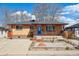 Charming brick home featuring a covered front porch and a low maintenance xeriscaped front yard at 2060 S Lowell Blvd, Denver, CO 80219