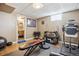 Home gym with weight-training equipment and a door leading to a remodeled bathroom at 2060 S Lowell Blvd, Denver, CO 80219