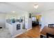 Open concept floor plan combining a bright white kitchen with the dining and living spaces at 2060 S Lowell Blvd, Denver, CO 80219