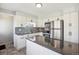 Modern kitchen with stainless steel appliances, sleek countertops, white cabinetry, and tiled backsplash at 2060 S Lowell Blvd, Denver, CO 80219