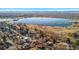 Stunning aerial view of a home near a tranquil lake, showcasing the city skyline and majestic mountains in the distance at 4215 W Byron Pl, Denver, CO 80212