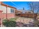 A spacious backyard with stone pavers and a covered patio, providing ample space for relaxing and entertaining at 4215 W Byron Pl, Denver, CO 80212