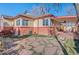 Brick home with a patio, flagstone walkway, and covered patio at 4215 W Byron Pl, Denver, CO 80212