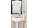Bright bathroom with pedestal sink, decorative mirror, and neutral decor at 4215 W Byron Pl, Denver, CO 80212