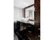 Elegant bathroom showcasing a vessel sink, dark wood cabinetry, and stylish tile backsplash at 4215 W Byron Pl, Denver, CO 80212