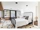 Cozy bedroom features bed with black frame, built in shelving, and an area rug at 4215 W Byron Pl, Denver, CO 80212