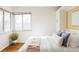 Bright bedroom with large window, hardwood floors, and built-in storage at 4215 W Byron Pl, Denver, CO 80212