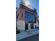 Modern brick building with large window, black door and steps leading up to the entrance at 4215 W Byron Pl, Denver, CO 80212