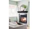 Inviting fireplace with decorative mantel, enhancing the room's cozy ambiance at 4215 W Byron Pl, Denver, CO 80212