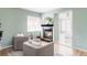 Cozy living room features an inviting fireplace, comfortable seating, and seamless flow to the bedroom at 4215 W Byron Pl, Denver, CO 80212