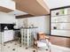 Stylish living area featuring unique glass block bar, built-in shelving, and modern furnishings at 4215 W Byron Pl, Denver, CO 80212