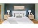Staged main bedroom features an upholstered headboard, natural wood nightstands, and muted, serene colors at 4215 W Byron Pl, Denver, CO 80212