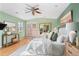 Bright, stylish main bedroom features an outdoor deck, ceiling fan and ensuite bathroom at 4215 W Byron Pl, Denver, CO 80212