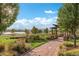 Beautiful park with lush landscaping, a lake view, shaded pergola, and walking path at 4215 W Byron Pl, Denver, CO 80212