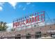 Exterior of the Edgewater Public Market, with a bright red neon sign and shops below at 4215 W Byron Pl, Denver, CO 80212