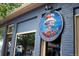 Eye-catching restaurant sign with a blue brick building in the background at 4215 W Byron Pl, Denver, CO 80212