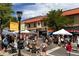 Outdoor town event with people enjoying the sunny day with many shops and restaurants in the background at 4215 W Byron Pl, Denver, CO 80212