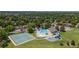 Aerial view of a community park featuring a pool, tennis courts, and playground for outdoor fun at 7276 W 83Rd Way, Arvada, CO 80003