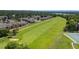 Community aerial view showcases lush golf course and tennis courts for active living, close to residences at 7276 W 83Rd Way, Arvada, CO 80003