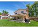 Spacious backyard featuring a large patio, lush green grass, and mature trees, perfect for outdoor entertaining at 7276 W 83Rd Way, Arvada, CO 80003