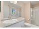 Bright bathroom with a shower, toilet, sink with vanity and a window that brings natural light at 7276 W 83Rd Way, Arvada, CO 80003