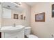 Cozy powder room with a pedestal sink, white toilet, and decorative wall art at 7276 W 83Rd Way, Arvada, CO 80003