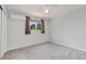 Bright bedroom with neutral tones, a ceiling fan, window with curtains and carpeted floor at 7276 W 83Rd Way, Arvada, CO 80003