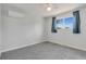 Well-lit bedroom featuring neutral walls, carpeting, and a window with bright outdoor views at 7276 W 83Rd Way, Arvada, CO 80003
