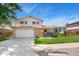 Charming two-story home featuring a lush lawn, brick accents, and an attached two car garage at 7276 W 83Rd Way, Arvada, CO 80003