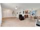 Cozy living space with plush carpet, leather armchair, and view of a sunlit dining area at 7276 W 83Rd Way, Arvada, CO 80003