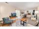 Comfortable living area with hardwood floors, a mounted TV, and a view of the adjoining kitchen at 7276 W 83Rd Way, Arvada, CO 80003