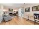 Cozy living room with light wood floors, fireplace, and an adjacent work space with natural light at 7276 W 83Rd Way, Arvada, CO 80003