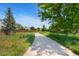 Paved path through a green space with trees, promoting an active lifestyle at 7276 W 83Rd Way, Arvada, CO 80003