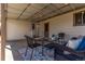 Covered back porch featuring outdoor furniture, overhead lighting, and access to house at 7720 Kendall St, Arvada, CO 80003