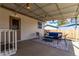 Covered back porch featuring outdoor furniture, overhead lighting, and access to yard at 7720 Kendall St, Arvada, CO 80003