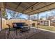 Covered back porch featuring outdoor furniture, overhead lighting, and a large area rug at 7720 Kendall St, Arvada, CO 80003