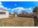 Backyard with a shed, green grass, and tall wooden fence at 7720 Kendall St, Arvada, CO 80003