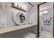 Bright bathroom vanity featuring round mirror with decorative vase and bright vanity lighting at 7720 Kendall St, Arvada, CO 80003