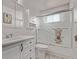 Clean bathroom with shower/tub combo, ample storage, and modern fixtures at 7720 Kendall St, Arvada, CO 80003