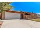 Charming single-story brick home featuring a spacious two-car garage and inviting front porch at 7720 Kendall St, Arvada, CO 80003