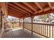 Covered front porch featuring a wood deck, railing, and view of the neighborhood at 7720 Kendall St, Arvada, CO 80003