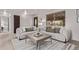 Bright living room with neutral tones, large windows, and stylish furniture at 7720 Kendall St, Arvada, CO 80003