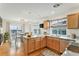 Bright kitchen featuring wooden cabinetry, granite countertops, stainless steel appliances, and hardwood flooring at 24285 E Wagon Trail Ave, Aurora, CO 80016