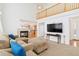 Inviting living room with a cozy fireplace, open floor plan, and a clear view of the modern kitchen at 24285 E Wagon Trail Ave, Aurora, CO 80016