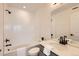 Stylish bathroom featuring modern fixtures, a white tile shower, and a vanity with a sleek design at 374 North Geneva, Aurora, CO 80010
